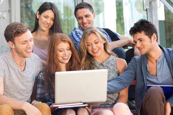 Students and DSA NMH Support Worker looking at laptop